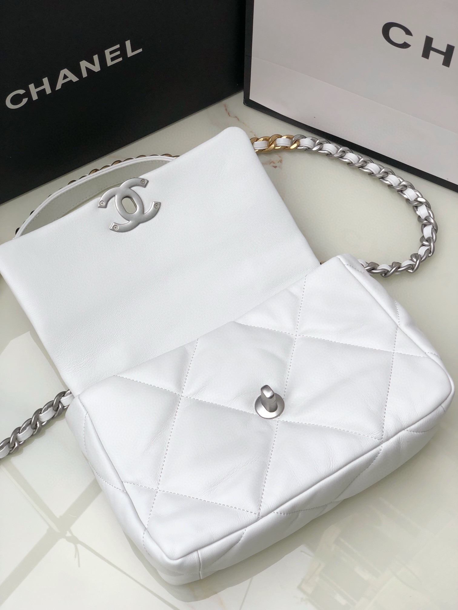 CHANEL 19 HANDBAG Shiny Leather, Gold-Tone, Silver-Tone & Ruthenium-Finish Metal White 6.2 × 10.1 × 3.5 in